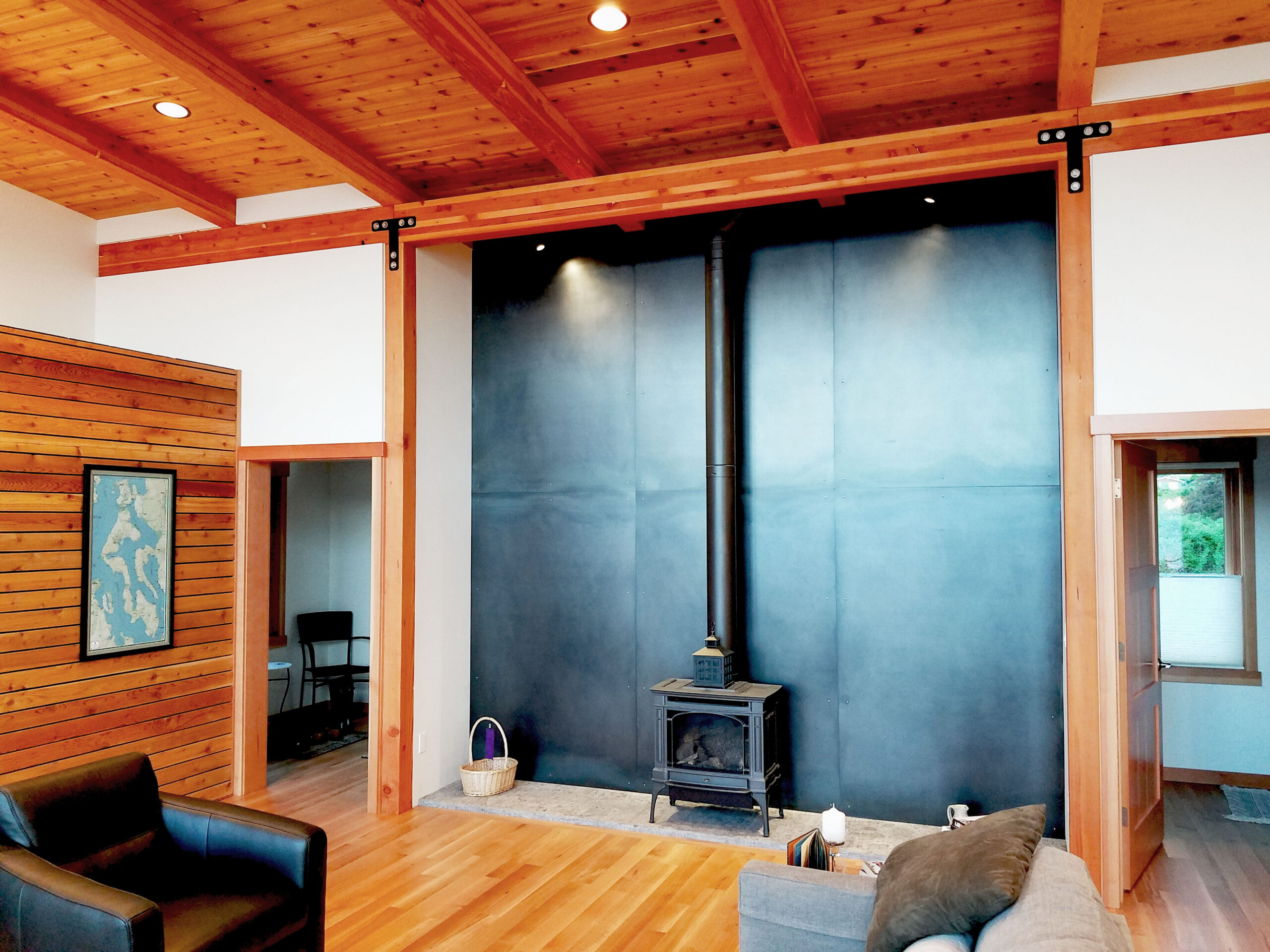 Josh Architecture wood burning stove and blackened steel panels